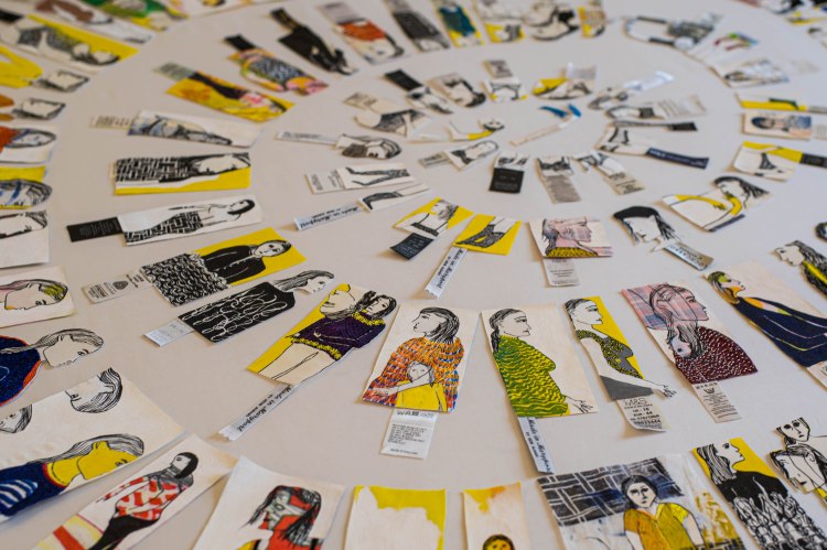 Image shows textile art comprising many printed and stitched textile pieces arranged in a spiral